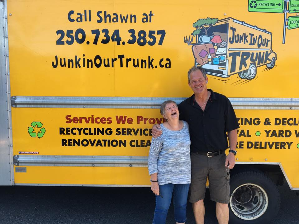A delighted Nanaimo client laughing with Shawn beside the Junk In Our Trunk truck