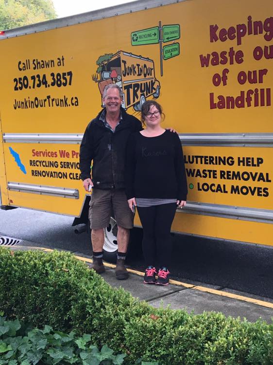 Shawn with a customer in front of the recycling-services side of the truck