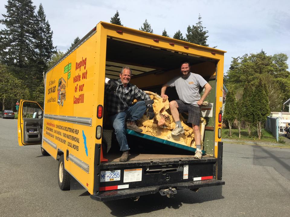Junk In Our Trunk crew loading an old mattress for responsible disposal