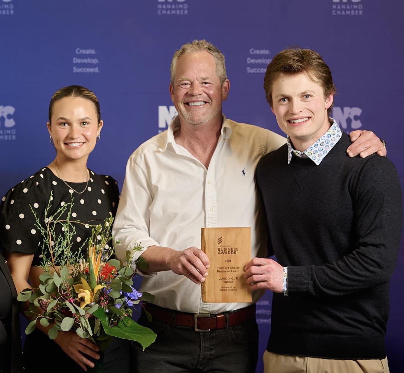 Shawn with his son and daughter at the Nanaimo Business Awards holding the People's Choice trophy for Junk In Our Trunk